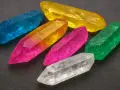Colorful crystals, like topaz, are found in igneous rocks and alluvial deposits worldwide.