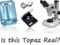 Tools for how to identify raw topaz: a large blue gemstone, a loupe, a scale, and a microscope.