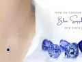 A delicate necklace with a blue sapphire pendant is shown alongside loose blue sapphire stones, illustrating how to choose the perfect gemstone for your jewelry.