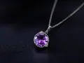 A stunning amethyst necklace, its deep purple aquarius stone sparkling against a dark, textured background.