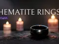 A dark hematite ring sits on a textured surface, illuminated by soft candlelight. Discover the hematite ring meaning.