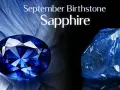 A faceted sapphire, the September birthstone, gleams next to a raw blue crystal.
