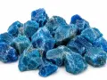 A pile of rough, blue apatite crystals. The apatite crystal meaning is often associated with motivation and ambition.