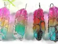 Four colorful crystal pendants, each wrapped in a wire-tree design, symbolizing hope and new beginnings.