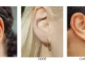 Close-up of ears showcasing different earring styles: huggie earrings, a twisted hoop, and a charm hoop with a spike pendant.