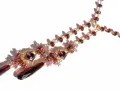 A gold necklace with various types of garnet, featuring deep red teardrop pendants and smaller faceted garnets in a rich, warm hue.