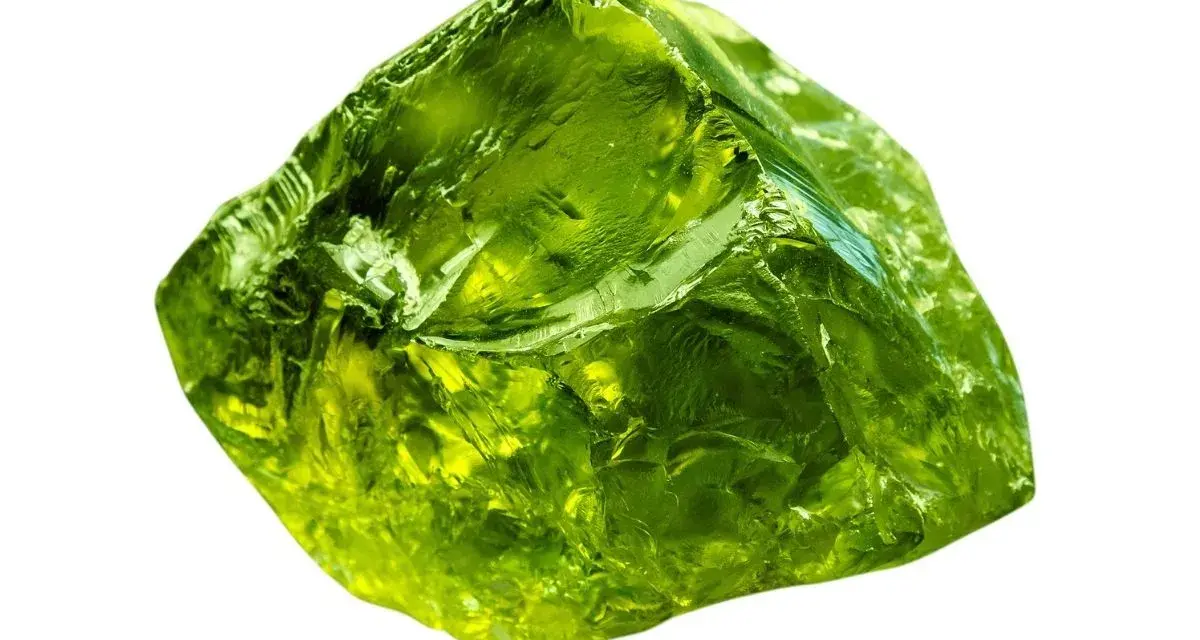 A rough, translucent green crystal, like an emerald, represents growth, renewal, and prosperity.