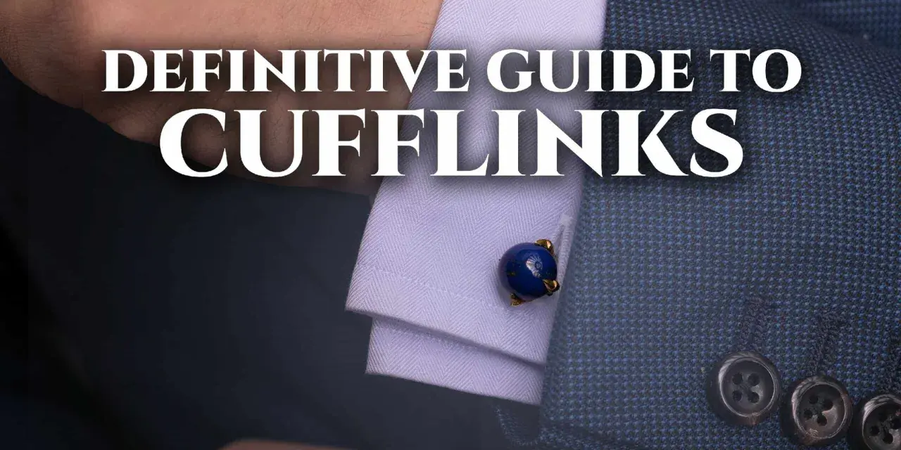 A close-up of a man's suit sleeve shows a blue lapis lazuli cufflink. This image is part of a definitive guide to cufflinks.