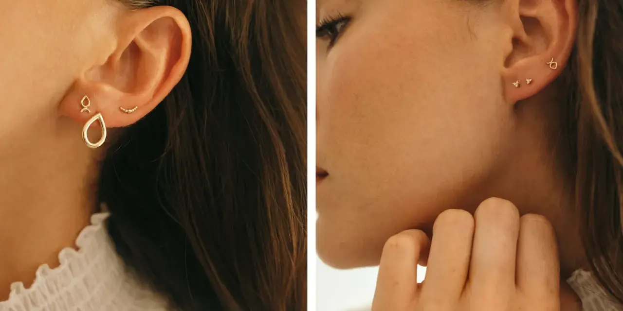 Chic ear stack ideas featuring delicate gold earrings: a teardrop charm, a curved bar, and tiny diamond studs.