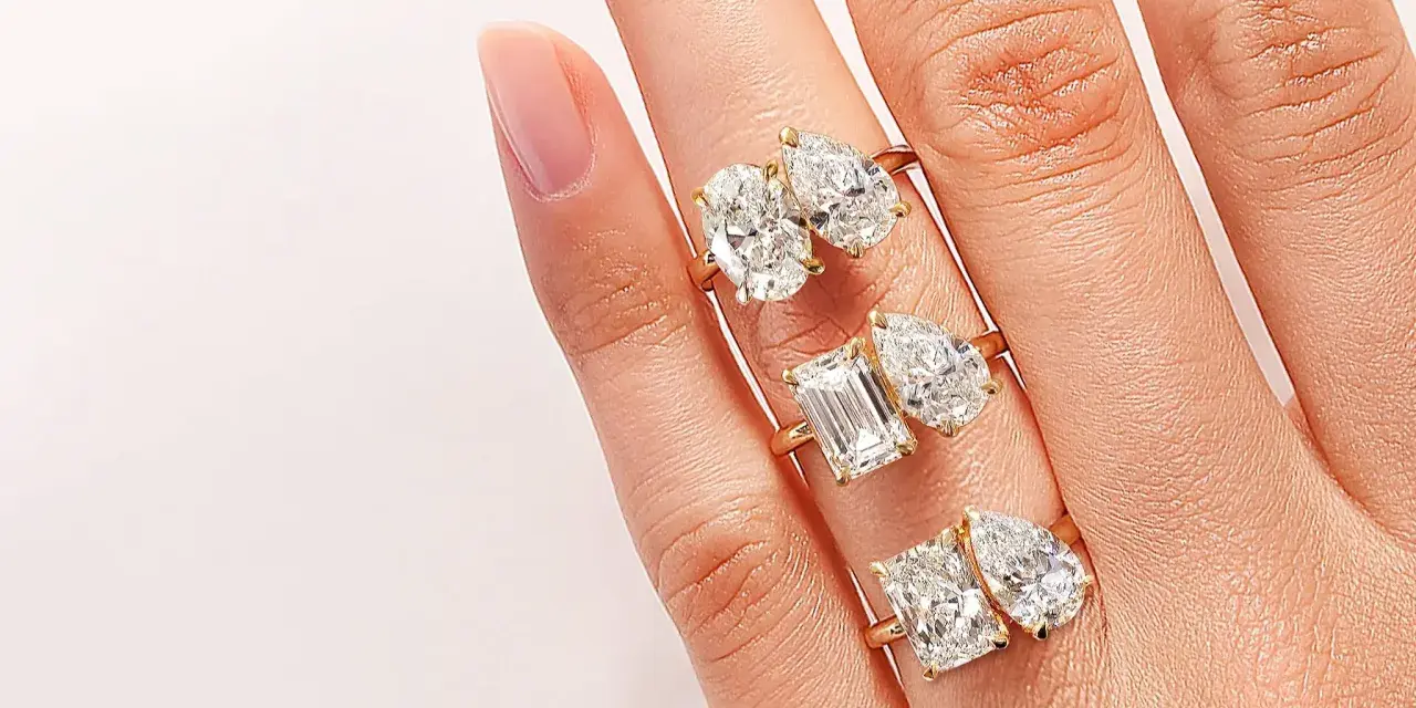 Three rings, each with two diamonds, symbolize the "toi et moi" meaning of "you and me.