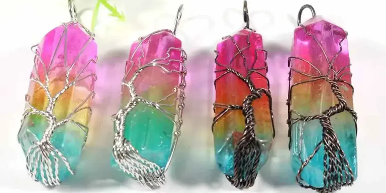 Four colorful crystal pendants, each wrapped in a wire-tree design, symbolizing hope and new beginnings.