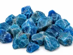 A pile of rough, blue apatite crystals. The apatite crystal meaning is often associated with motivation and ambition.