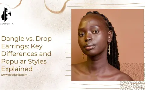 A woman models geometric drop earrings, showcasing how these elegant pieces hang below the earlobe.