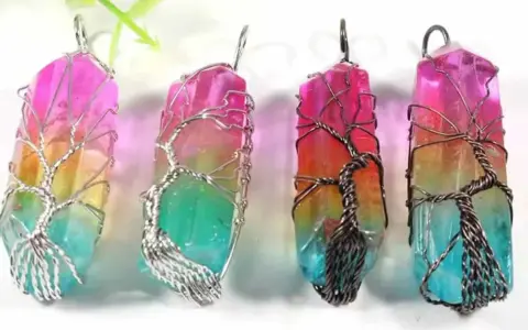 Four colorful crystal pendants, each wrapped in a wire-tree design, symbolizing hope and new beginnings.