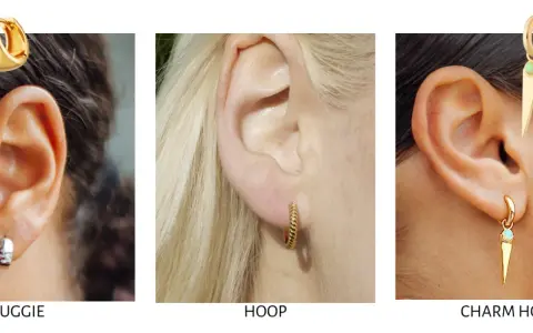 Close-up of ears showcasing different earring styles: huggie earrings, a twisted hoop, and a charm hoop with a spike pendant.