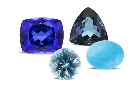 A cushion-cut tanzanite, a trillion-cut blue topaz, and a cabochon-cut turquoise are shown, representing what are December birthstones.