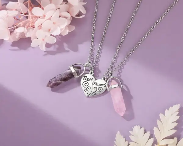 Two necklaces with amethyst and rose quartz crystals, symbolizing the enduring bond of friendship.