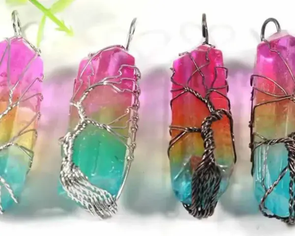 Four colorful crystal pendants, each wrapped in a wire-tree design, symbolizing hope and new beginnings.