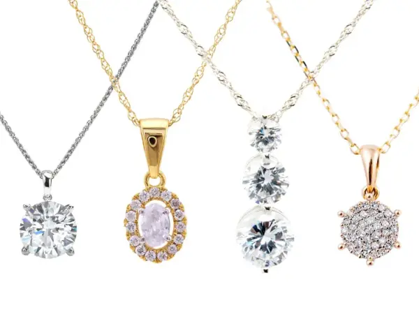 Four elegant diamond chains showcase different styles: a solitaire, an oval halo, a cascading trio, and a cluster pendant.