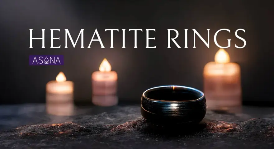 A dark hematite ring sits on a textured surface, illuminated by soft candlelight. Discover the hematite ring meaning.