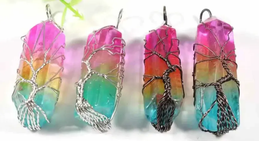 Four colorful crystal pendants, each wrapped in a wire-tree design, symbolizing hope and new beginnings.