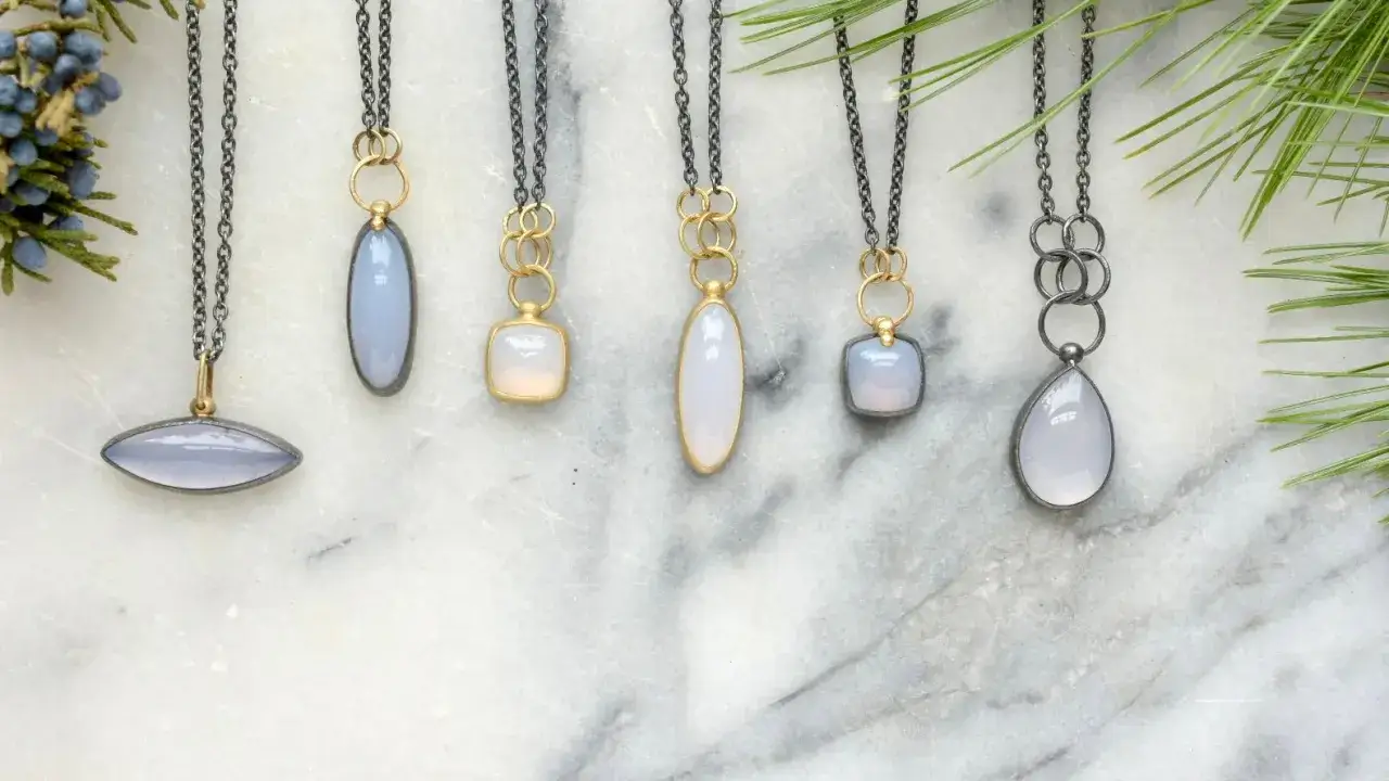 Six necklaces with chalcedony pendants in various shapes and settings, evoking calm and clarity.