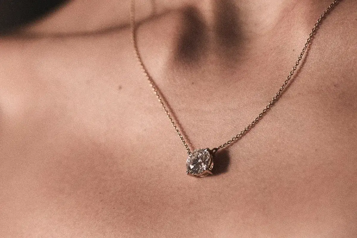 A delicate gold chain holds a sparkling diamond, the perfect symbol for an april birthstone.
