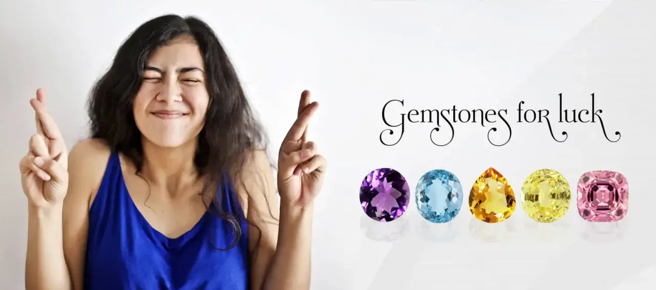 A woman crosses her fingers, hoping for good luck, with a row of colorful gemstones for good luck displayed beside her.