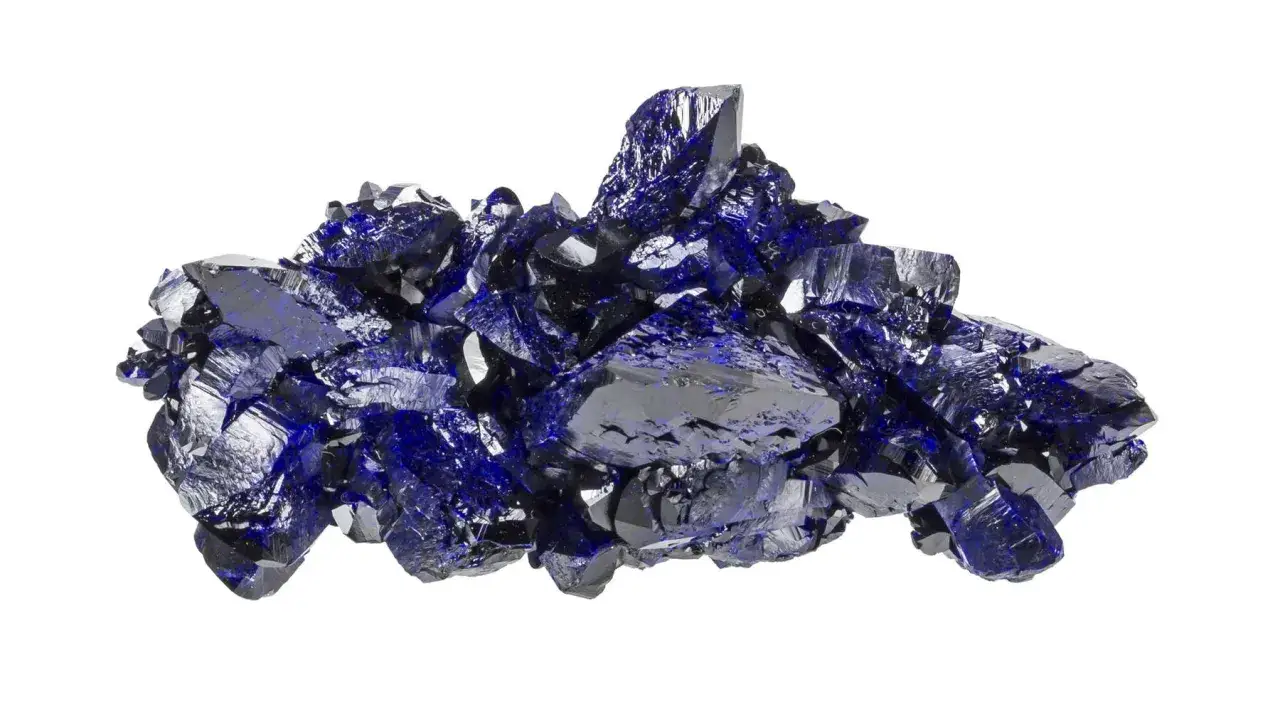 A cluster of sharp, dark blue azurite crystals, glistening like a deep ocean under light.