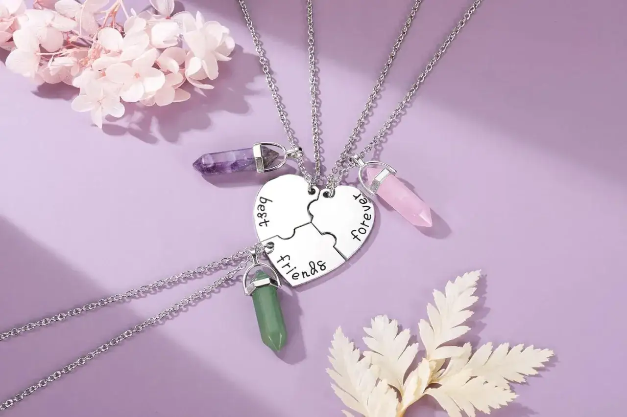 Three necklaces with puzzle heart pendants and colorful crystals for friendship.