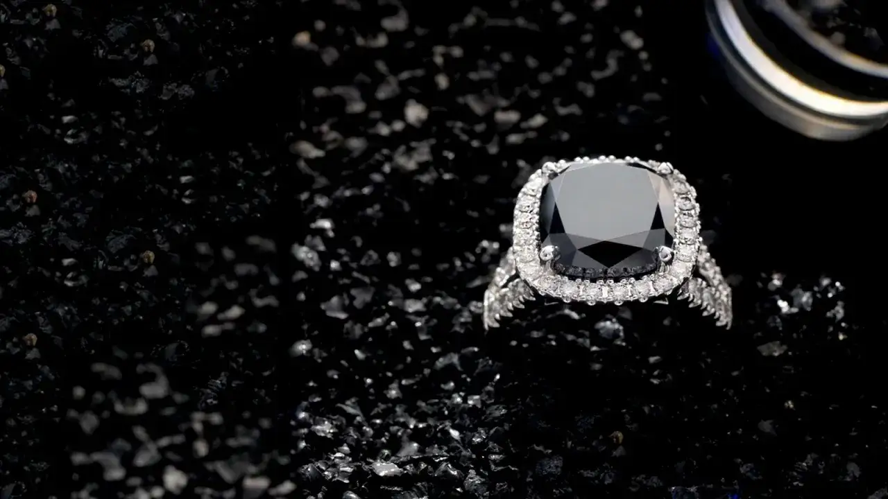 A black diamond ring, surrounded by tiny black stones, gleams against a dark background.